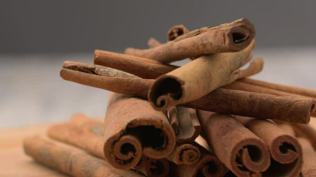 Christmas cinnamon isolated. Spices. Cinnamon rotates. Cinnamon sticks rotate on background. Fragrant cinnamon seasoning. &nbsp;Spicy cinnamon seasoning for baked goods, fruit desserts, puddings and drinks