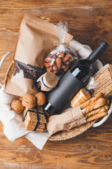 Gift basket with products on wooden background