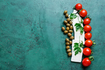Tasty feta cheese, tomatoes and olives on color background