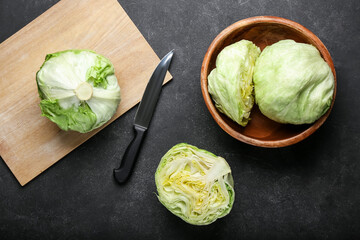 Bowl with iceberg lettuce on dark background