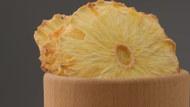 Dried pineapple. Dried pineapples on the table. Dried pineapples on the table.  Rotating Dried Pineapple rings seamless loopable. Dried Pineapple rings seamless. Fresh made Dried Pineapple rings. 
