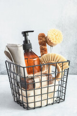 Metal basket with natural cleaning products and tools. Bamboo accessories and natural products for cleaning the kitchen. Copy space - Image