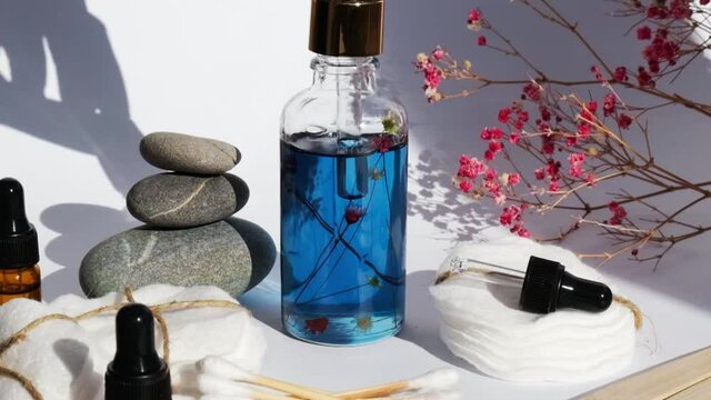 Reusable and recycable bathroom accessories on white background. Trendy shadows. Zero waste concept. Natural cosmetics and eco living concept. Essential oil or serum