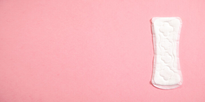 Menstrual pad on a pink background.