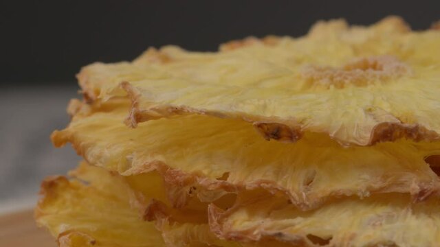 Dried pineapple. Dried pineapples on the table. Dried pineapples on the table.  Rotating Dried Pineapple rings seamless loopable. Dried Pineapple rings seamless. Fresh made Dried Pineapple rings. 
