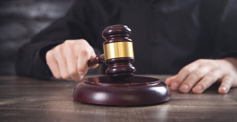 Male judge in a courtroom striking the gavel.