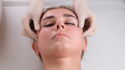 Fototapeta na wymiar Beautiful woman in salon having facial massage.