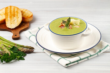 Cream soup, green asparagus, on a white background, healthy food, horizontal, no people,