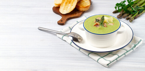 Cream soup, green asparagus, on a white background, healthy food, horizontal, no people,