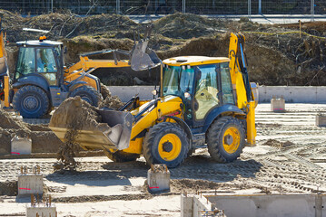 Heavy machinery at a construction site. growth of the real estate market. Construction of an...