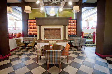 Colorful stylish interior of restaurant with fireplace