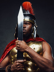 Roman soldier holding sword near his face
