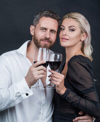 sexy couple in love of woman and man with wine glass embrace and celebrate spacial occasion, date