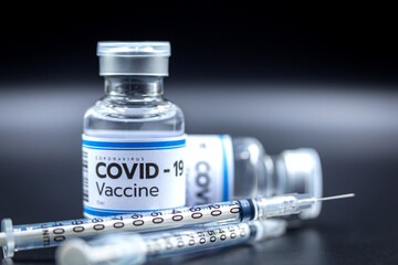 Close up Vaccine and syringe injection, treatment to cure Covid 19 Coronavirus. , Its uses for...