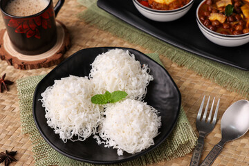 Noolappam/Idiyappam/rice noodles, a popular traditional steam cooked Kerala breakfast dish with hot and spicy egg roast curry on a houseboat, Alleppey, India. South Indian food. noolputtu Sri lankan