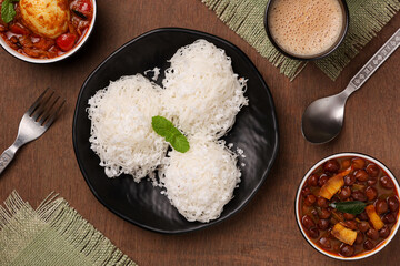 Noolappam/Idiyappam/rice noodles, a popular traditional steam cooked Kerala breakfast dish with hot and spicy egg roast curry on a houseboat, Alleppey, India. South Indian food. noolputtu Sri lankan