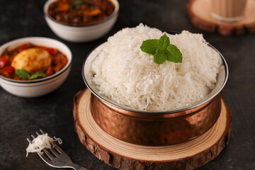 Noolappam, Idiyappam, rice noodles a popular traditional steam cooked Kerala breakfast dish with hot and spicy egg roast curry on a houseboat, Alleppey, India. South Indian food. noolputtu Sri lankan