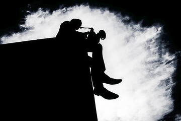 A man sits on the edge of the roof and plays a saxophone, black and white photo. A musician on the...