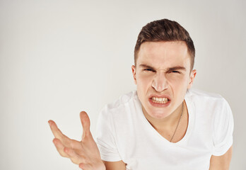 man gesturing with his hands indignant look light background cropped view Copy Space