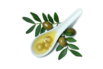 Spoon with olive oil, olives and twigs isolated on white background