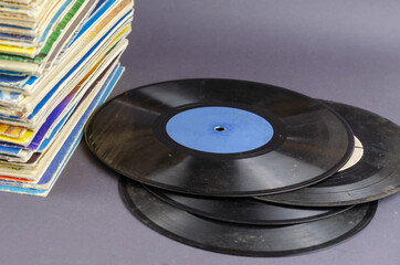 A collection of old comics, magazines, and vinyl records on a gray background.