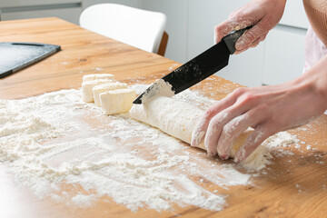 Hands preparing dough. Woman hands knead dough on a table