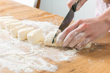 Woman making dough at kitchen