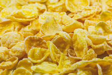 Yellow Cornflakes close up photo, Food texture background, top view. Macro shot. Perfect breakfast.
