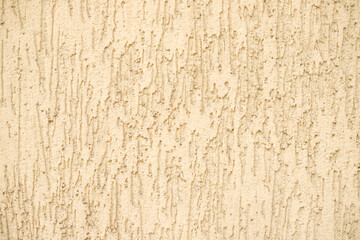 Concrete beige wall background on the street.