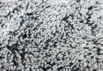 Grey cotton towel or carpet.fluffy texture background. Close up, macro photo. Soft focus image.