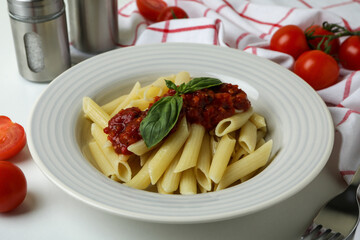 Concept of tasty food with pasta with tomato sauce on white background