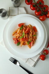 Concept of tasty food with pasta with tomato sauce on white background