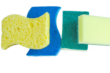 Four sponges for washing and cleaning lie on top of each other and on a white background.