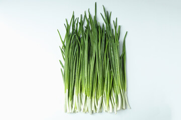 Fresh green onion with water drops on white background