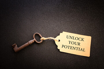 unlock your potential concept. vintage key with tag - obrazy, fototapety, plakaty