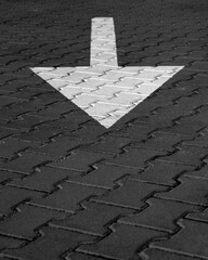  Large White arrow symbol painted on the road. asphalt road with drawn direction.