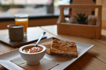 Toasted bread with tomato. Toast with crushed tomato. Delicious continental breakfast. Breakfast of toast with tomato, coffee and orange juice.