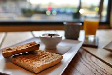 Toasted bread with tomato. Toast with crushed tomato. Delicious continental breakfast. Breakfast of toast with tomato, coffee and orange juice.
