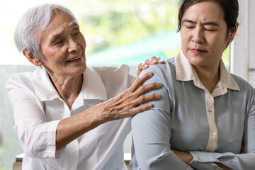 Asian senior grandmother reconcile touchy her granddaughter,angry upset woman with crossed arms,old elderly trying to reconcile by shoulder squeeze after conflict,misunderstanding,family life problems