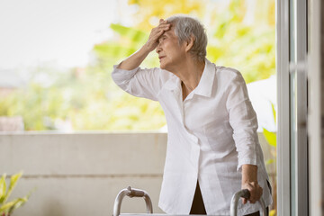 Exhausted senior woman has headache dizziness from the sizzling summer temperatures,old elderly...