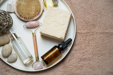 Clean organic skincare products with oil , serum, natural soap, body brush and quartz roller