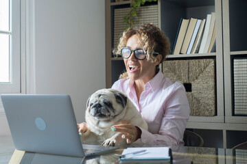 People working at home with internet connection and laptop computer - funny scene with cheerful female people in video call conference and playful cute pug dog friend together - smart working - obrazy, fototapety, plakaty