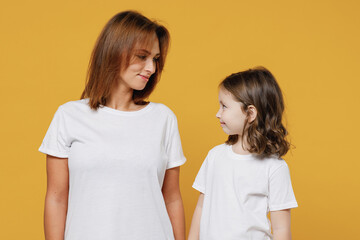 Happy woman in white t-shirt have fun with cute child baby girl 5-6 years old look to each other....
