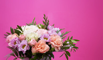 Beautiful bouquet of mixed different flowers on pink background, greeting, gift