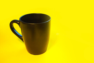 Bright yellow background black cup