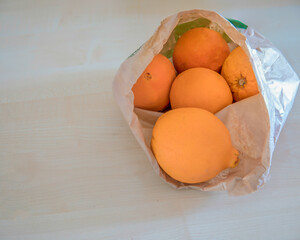 Oranges In Paper Bag. Copy Space. Five fresh oranges inside a grocery paper bag. Isolated. Stock Image.