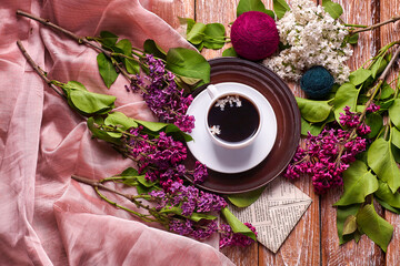 Coffee Cup And Colorful Lilac Flowers On Garden wooden Table
