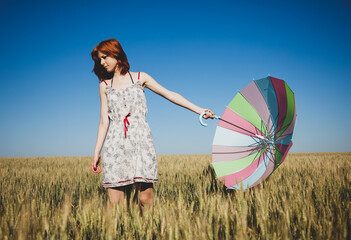 Girl with umbrella at field