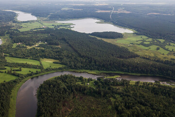 Fototapeta na wymiar Aerial view of river bend and forests on a sunny summer day. 
