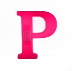 Plastic letter P of the English alphabet against white background, top view.